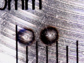 two micro-burnspots under microscope